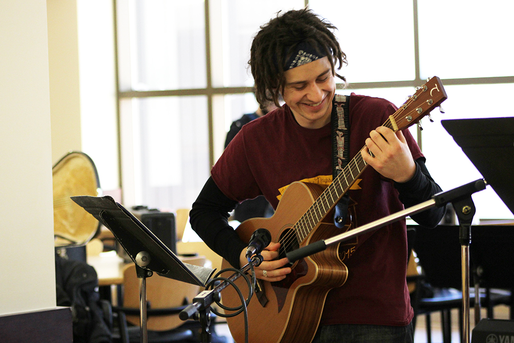 Marley Richards playing guitar at Jennings Hall.
